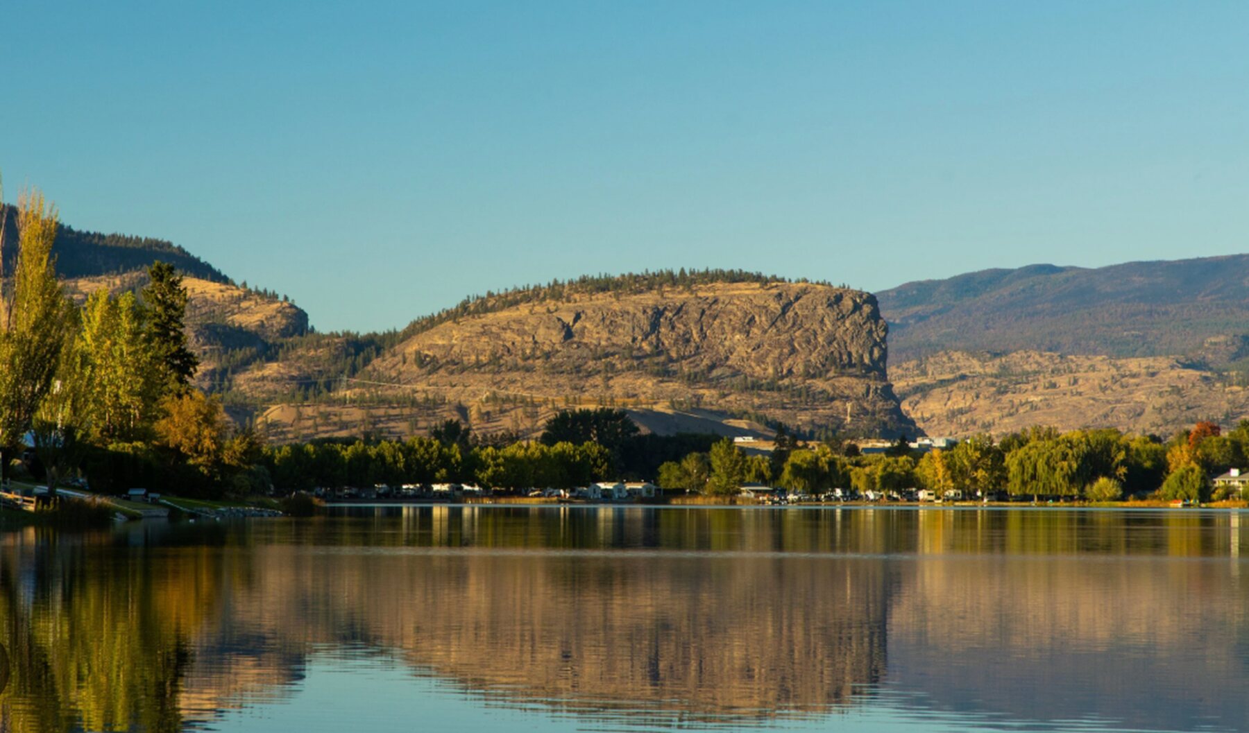 Golden-hour reflection on the lake below the bluffs near Oliver, BC